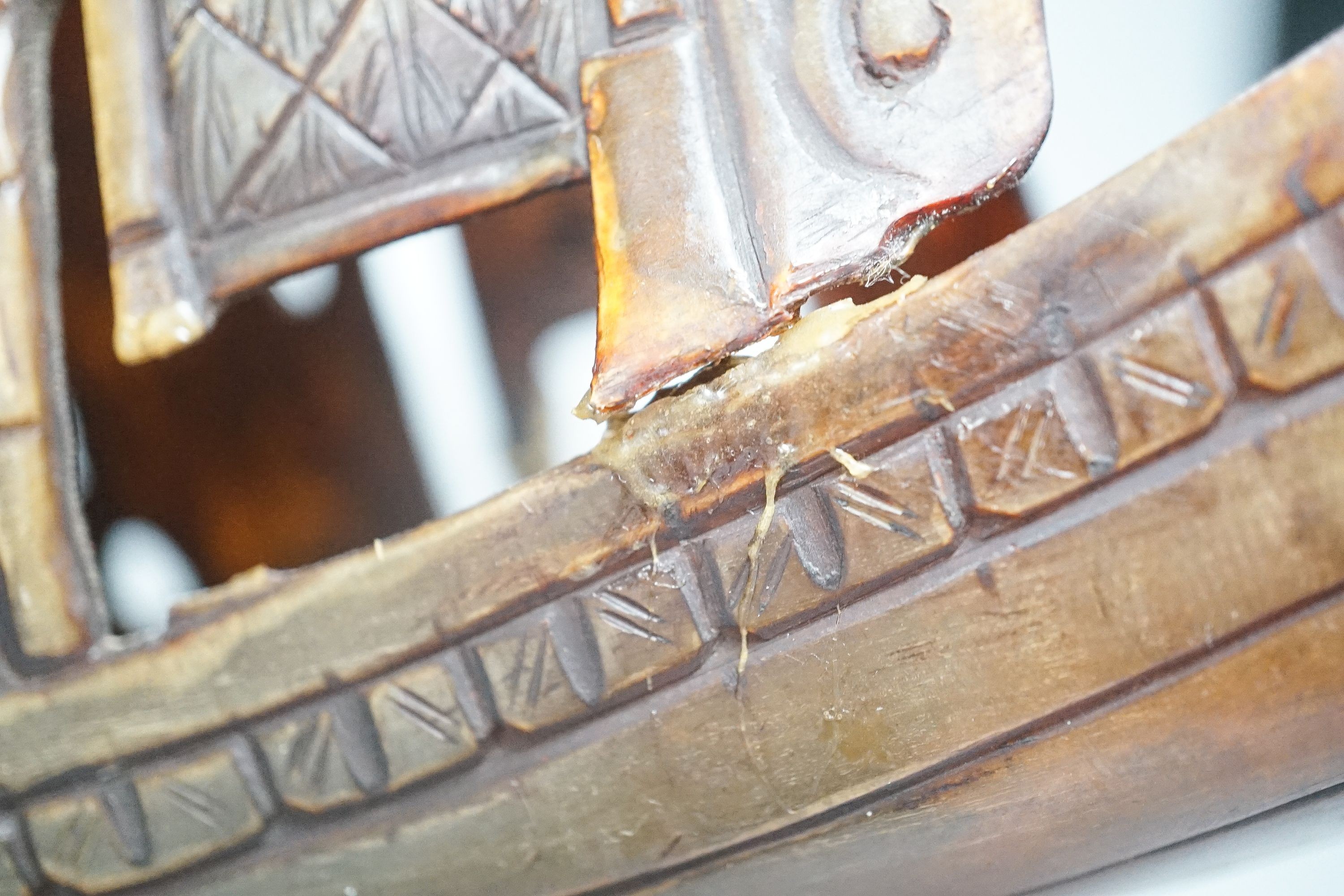 A Chinese horn carving of a junk boat, wood stand, 34cm